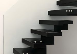 A modern staircase with floating black steps and a glass railing.